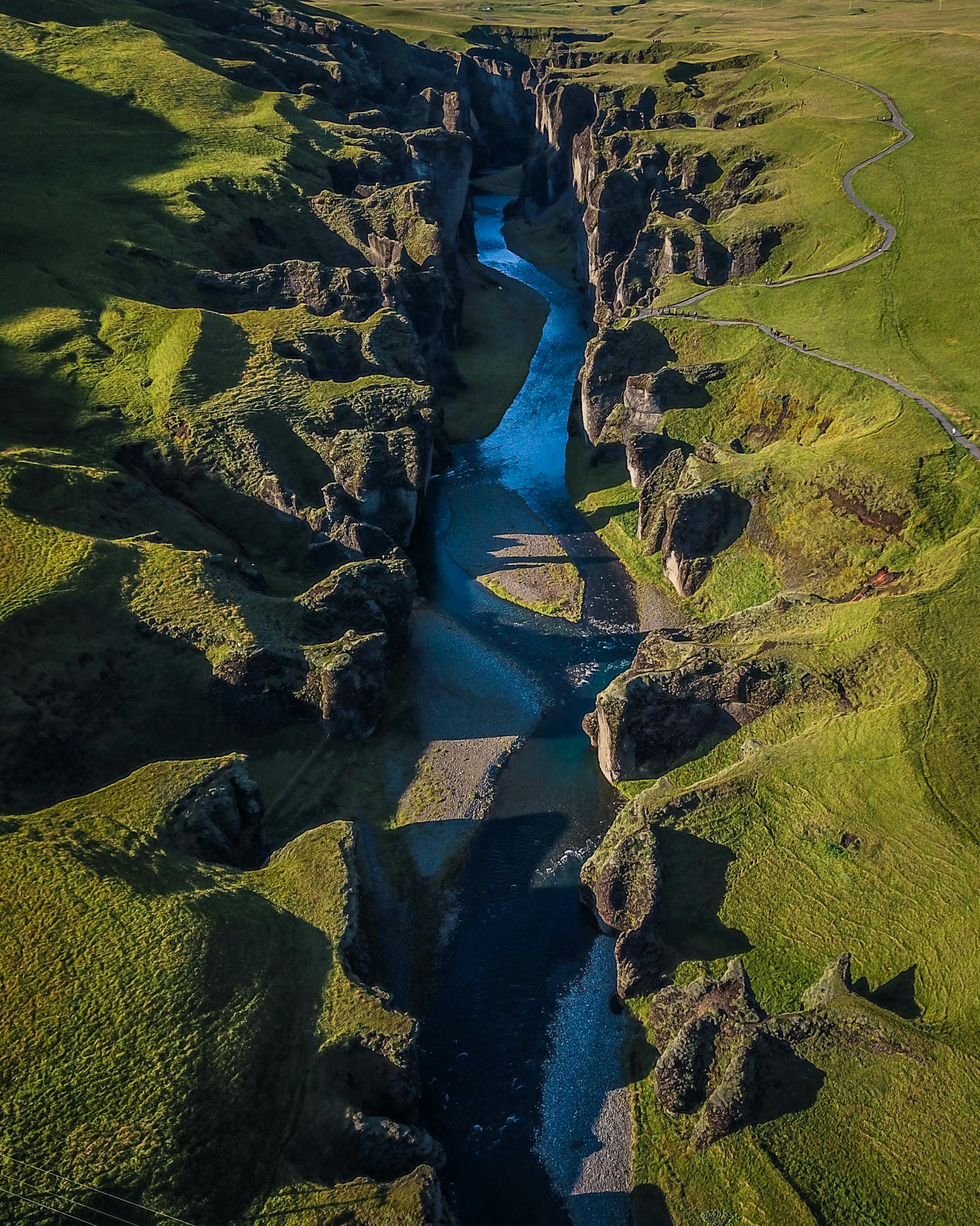 Stunning aerial photograph of a canyon in Iceland, showcasing rugged cliffs and a winding river.